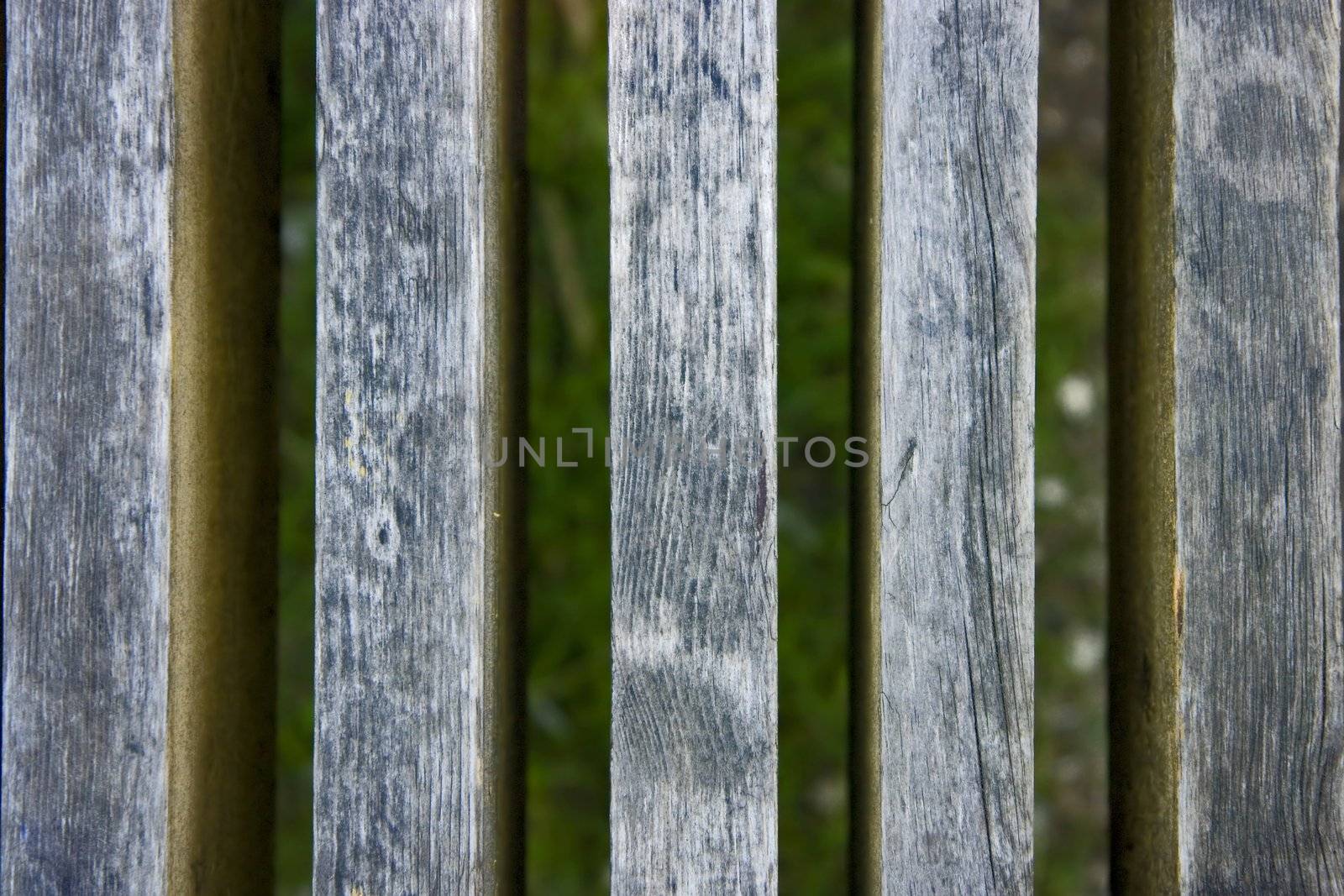 Photo of an old fence against a grass