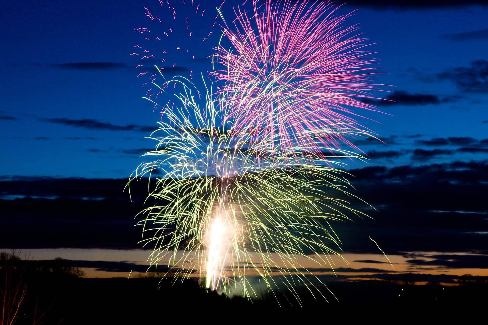 Bright and coloufull fireworks with cloudy night time sky