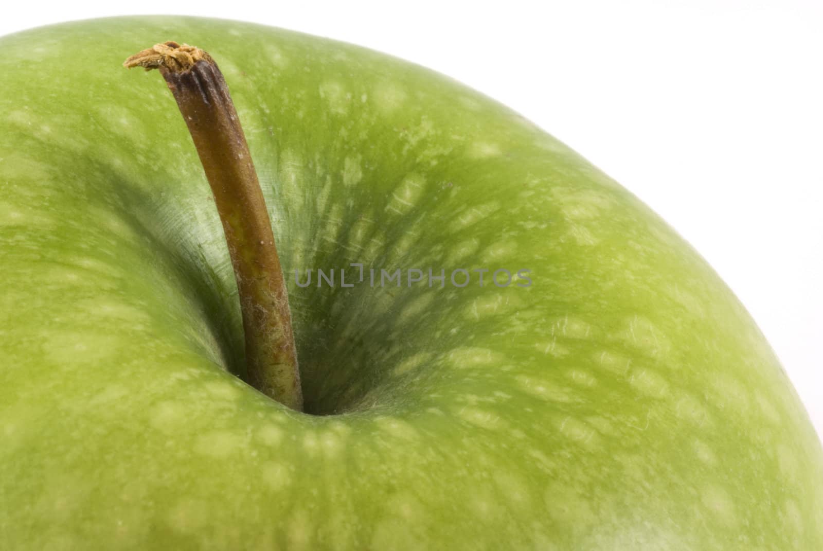 Part of a delicious green apple isolated on white.