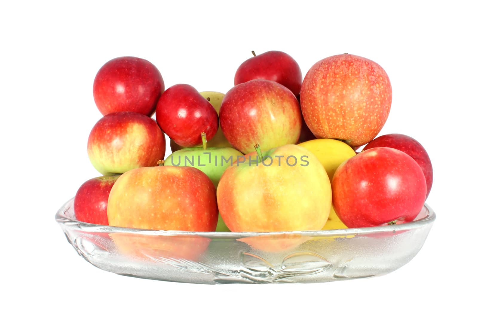 Diverse kind of apples in a glass bowl isolated on white