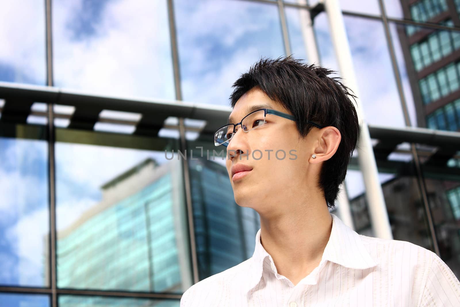 asian young, handsome business man at the office building .