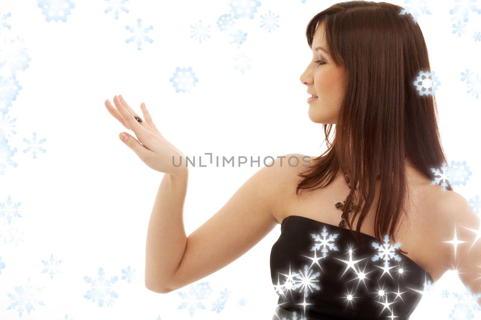 portrait of lovely brunette with engagement ring and snowflakes