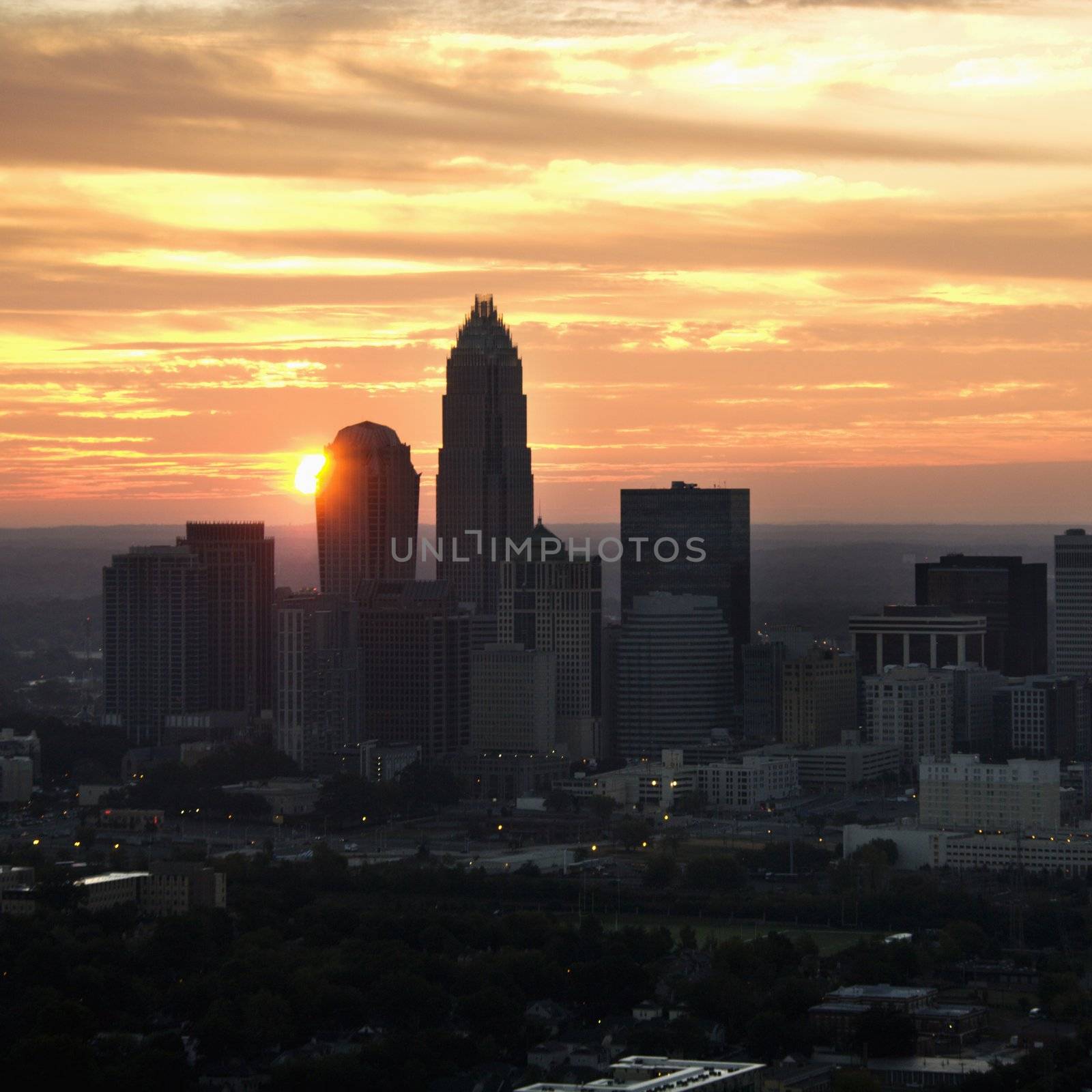 Aerial view of sunset behind city skyline of Charlotte, North Carolina.