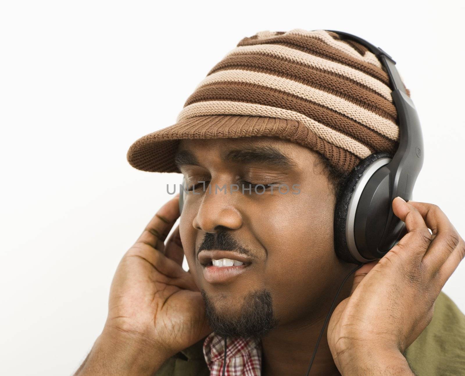 Man listening to headphones. by iofoto