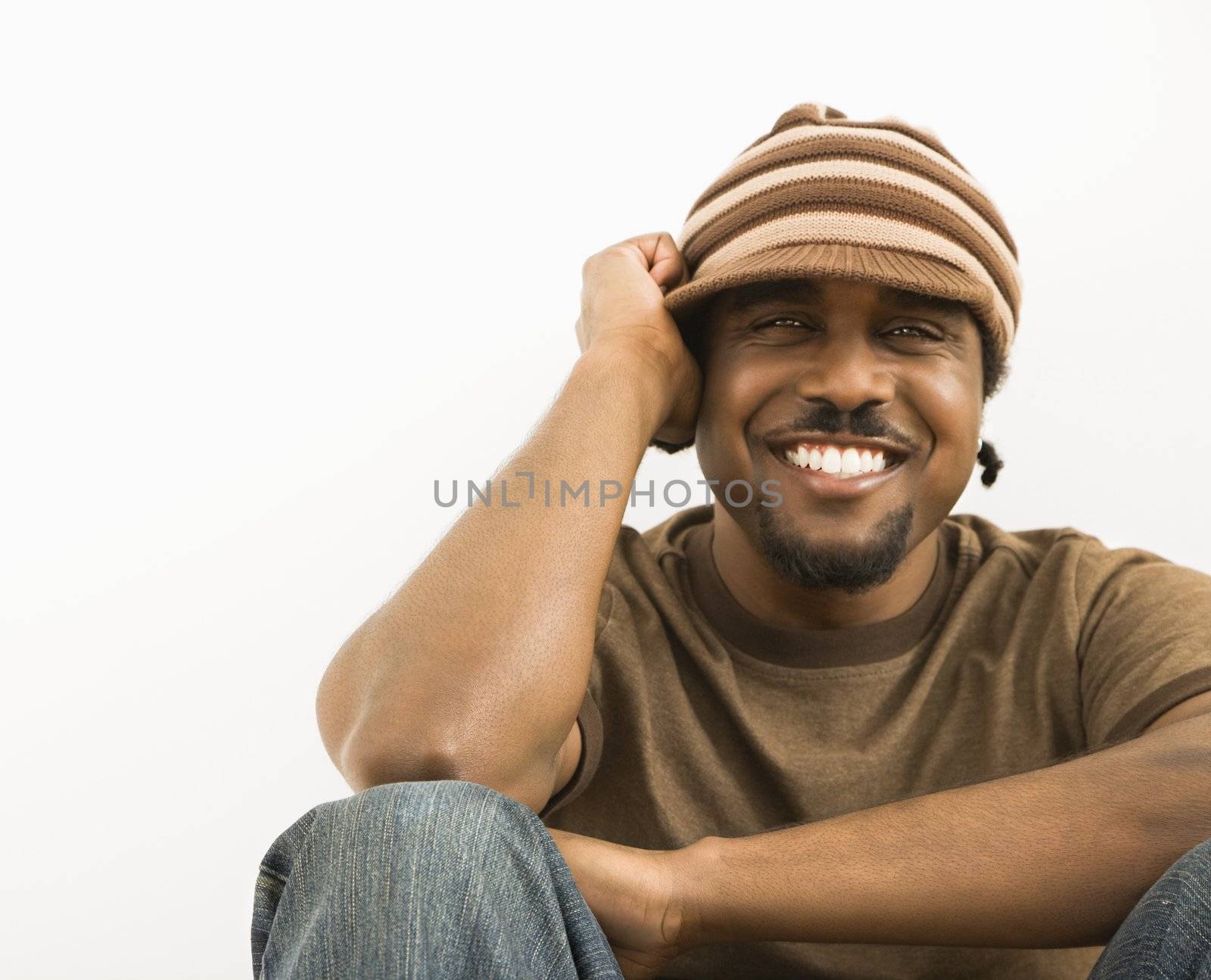African-American mid-adult man wearing knit hat smiling at viewer.