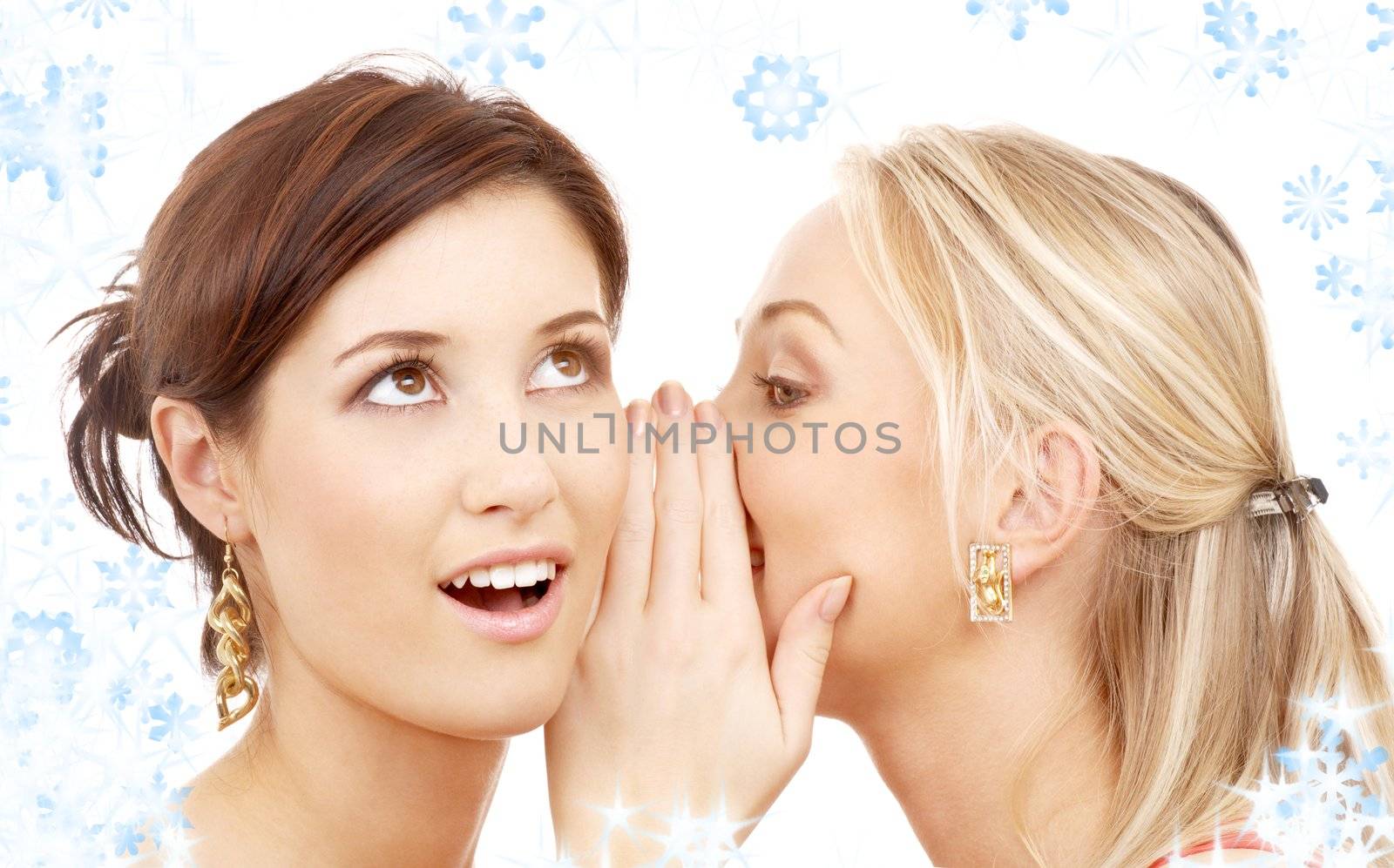 two happy young girlfriends with twinkles and snowflakes