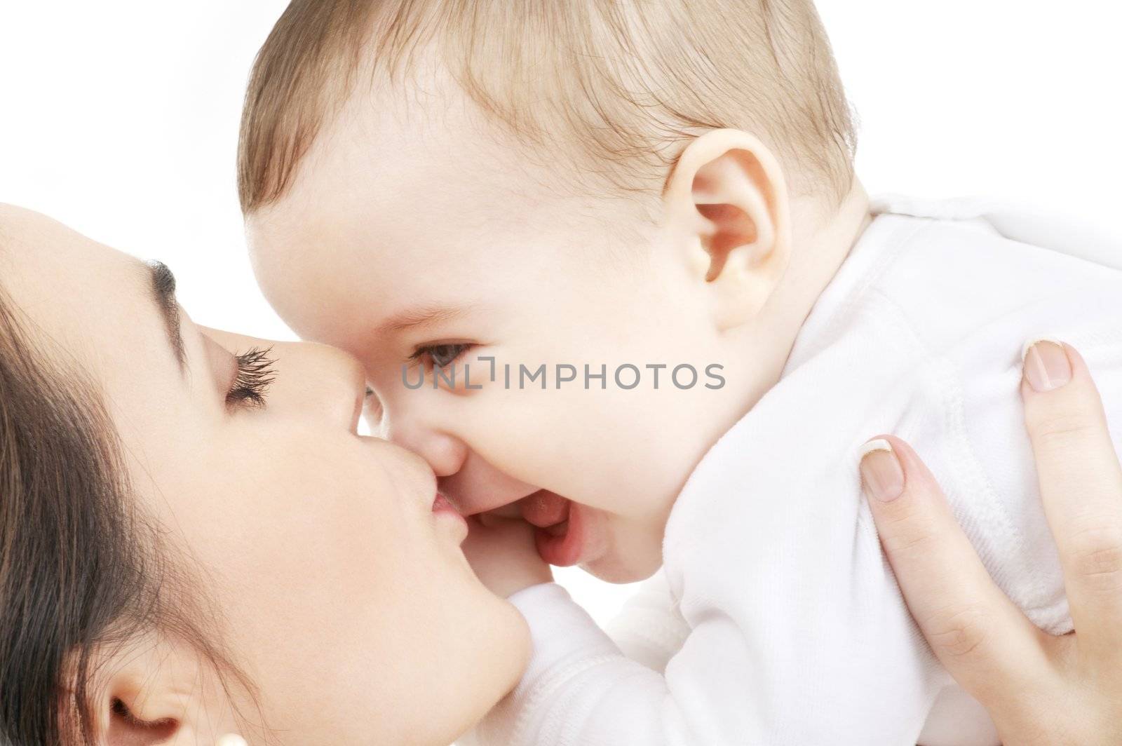 happy mother kissing baby boy by dolgachov