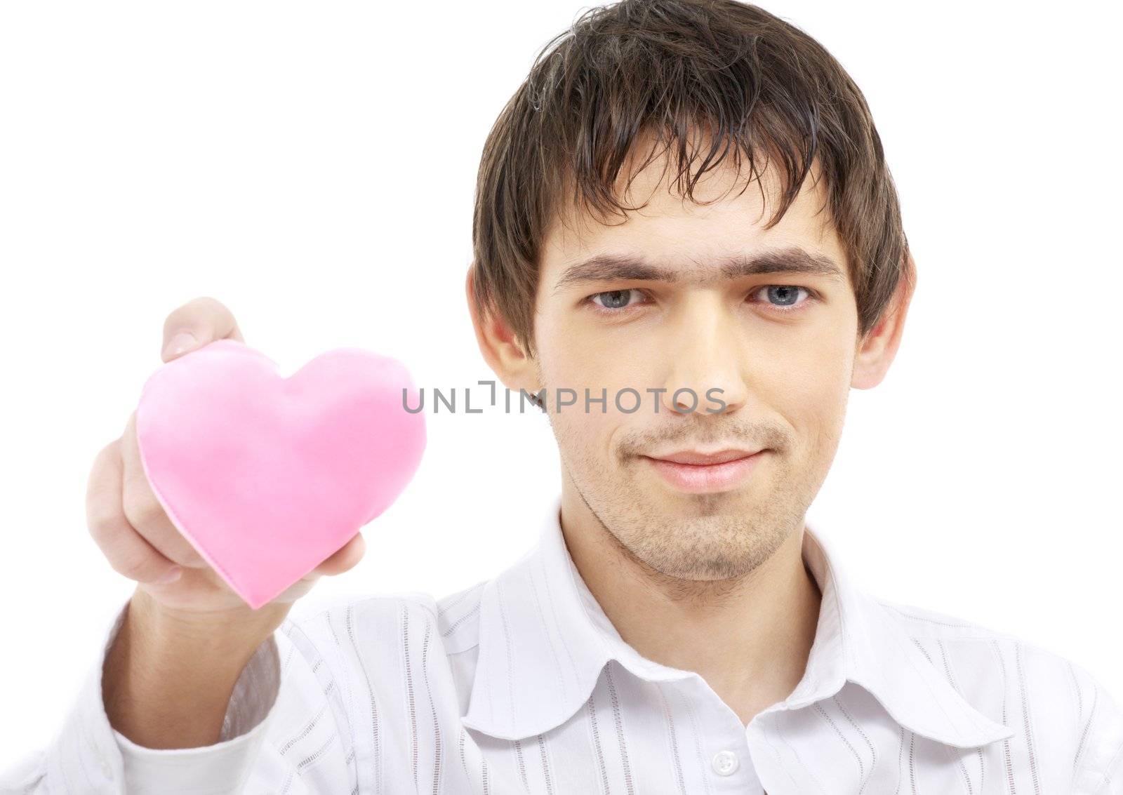 portrait of handsome man giving pink heart-shaped pillow