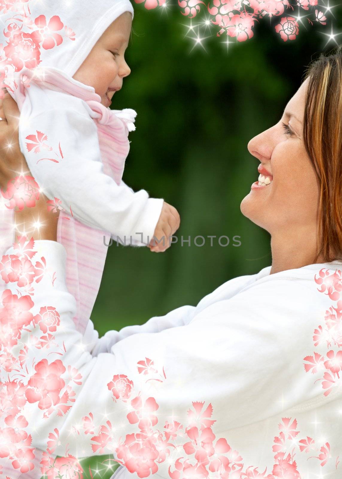 outdoor picture of happy mother with baby and flowers (focus on mom)
