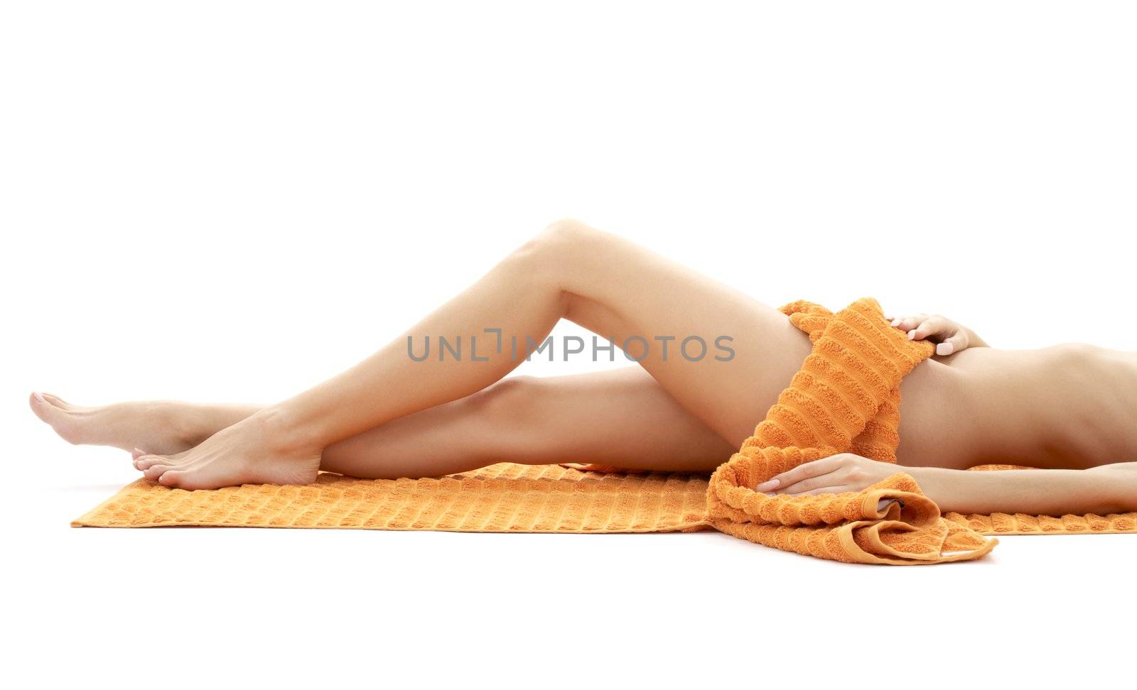 long legs of relaxed lady with orange towel over white