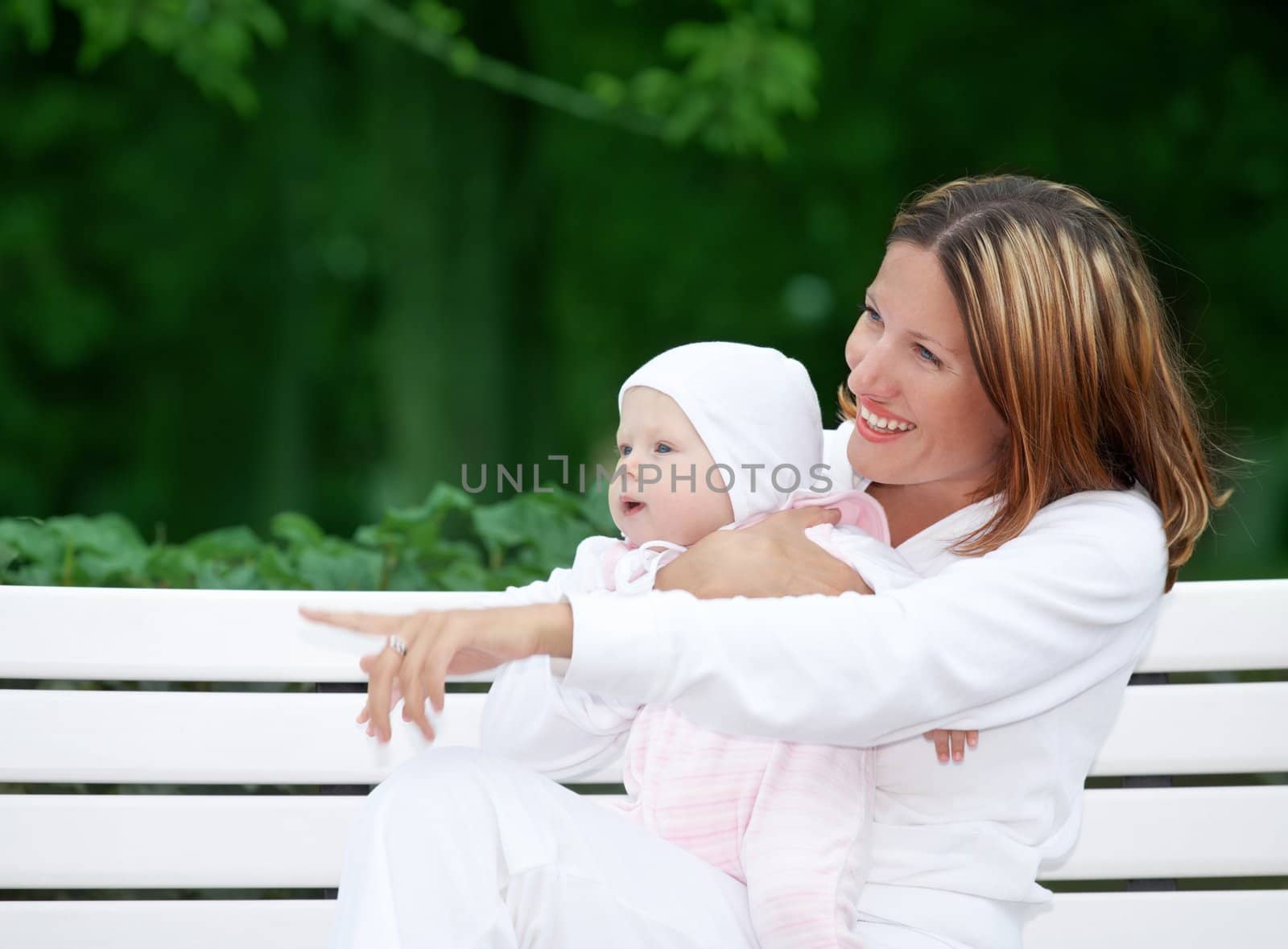 happy mother with baby on the bench by dolgachov