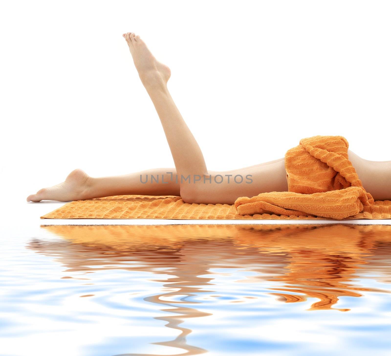 long legs of girl with orange towel on white sand #2 by dolgachov