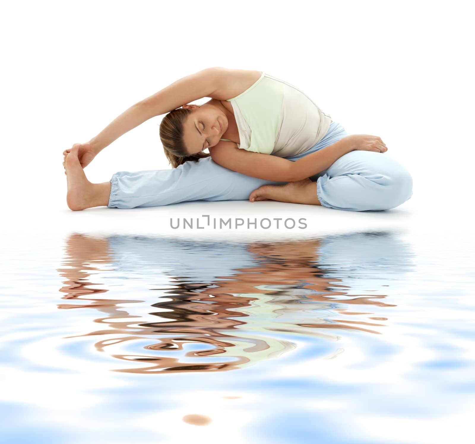 lovely girl practicing ashtanga yoga on white sand