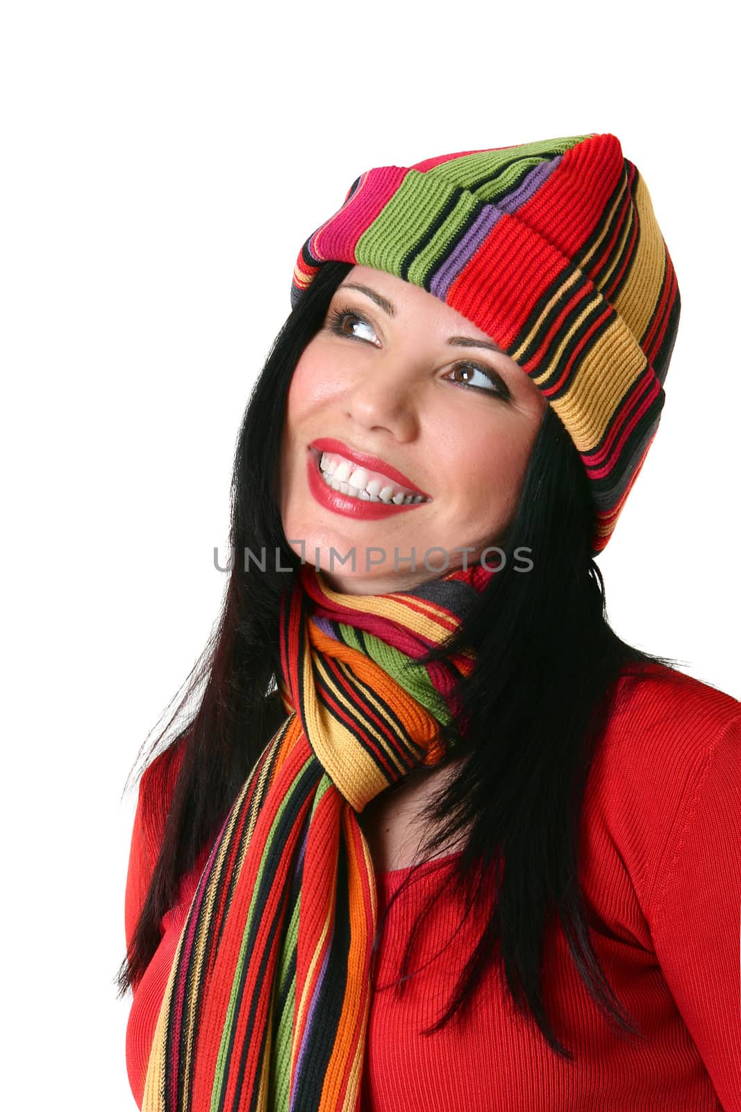 A beautiful smiling woman wearing vibrant happy colours.  She is looking sideways.  Suitable for copy.  White background.