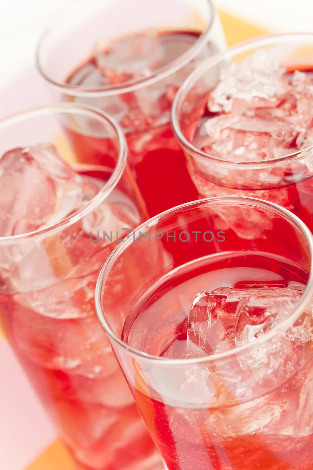 Chilled red beverage with ices on the tall glass