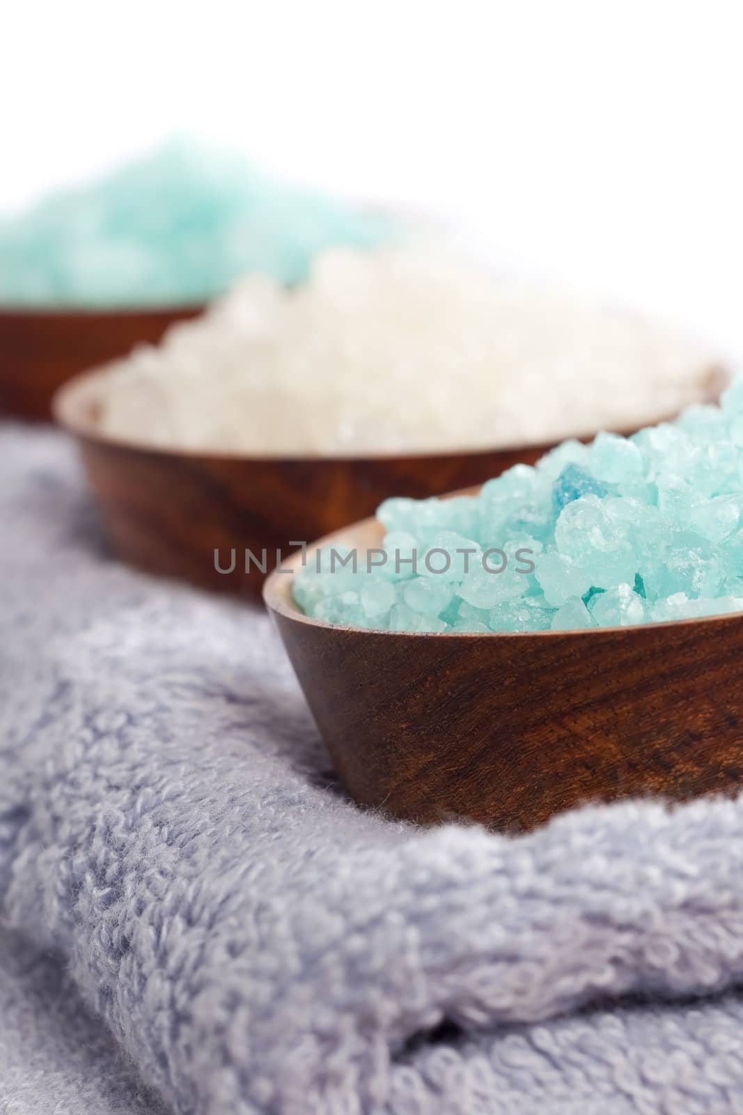 Bath salt on wooden cups on the towel