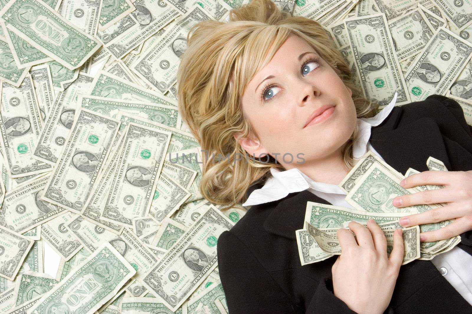 Beautiful woman laying in money