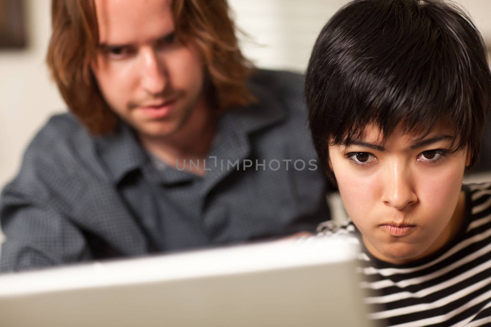 Young Man and Diligent Woman Using Laptop Computer Together.