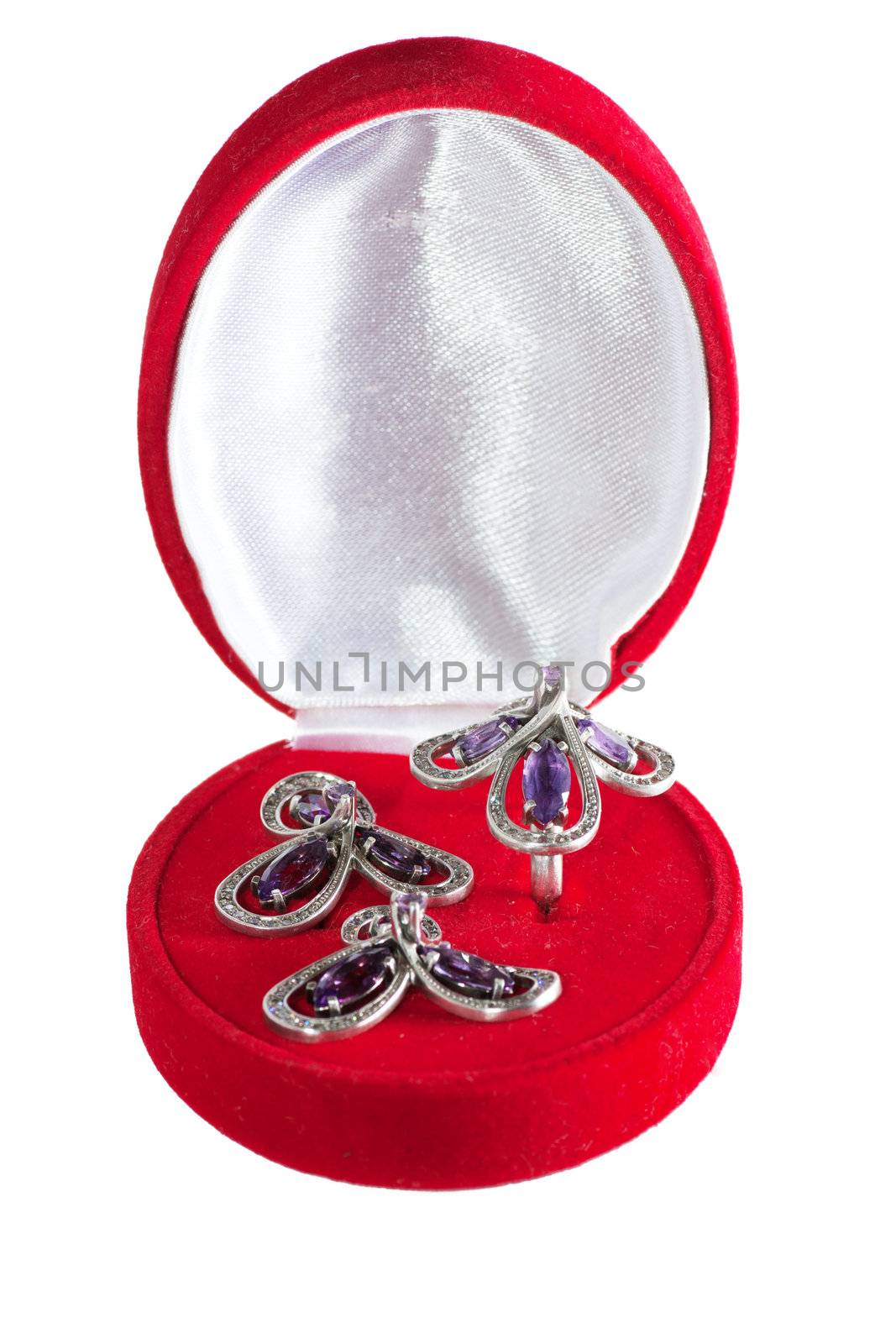 Closed gift box with ring and earrings inside isolated over white