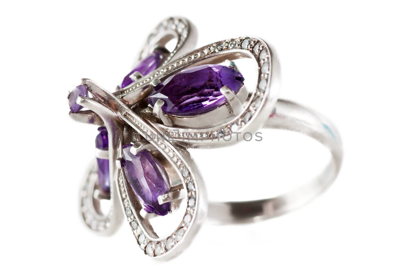 Macro view of old silver ring with violet gems.