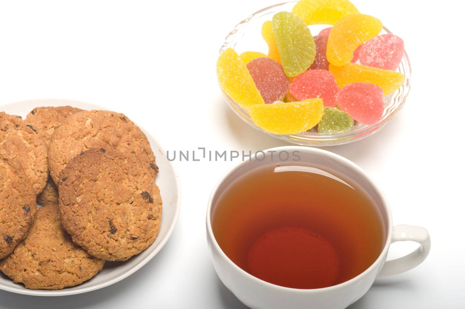 Tea colour fruit candy and cookies close up