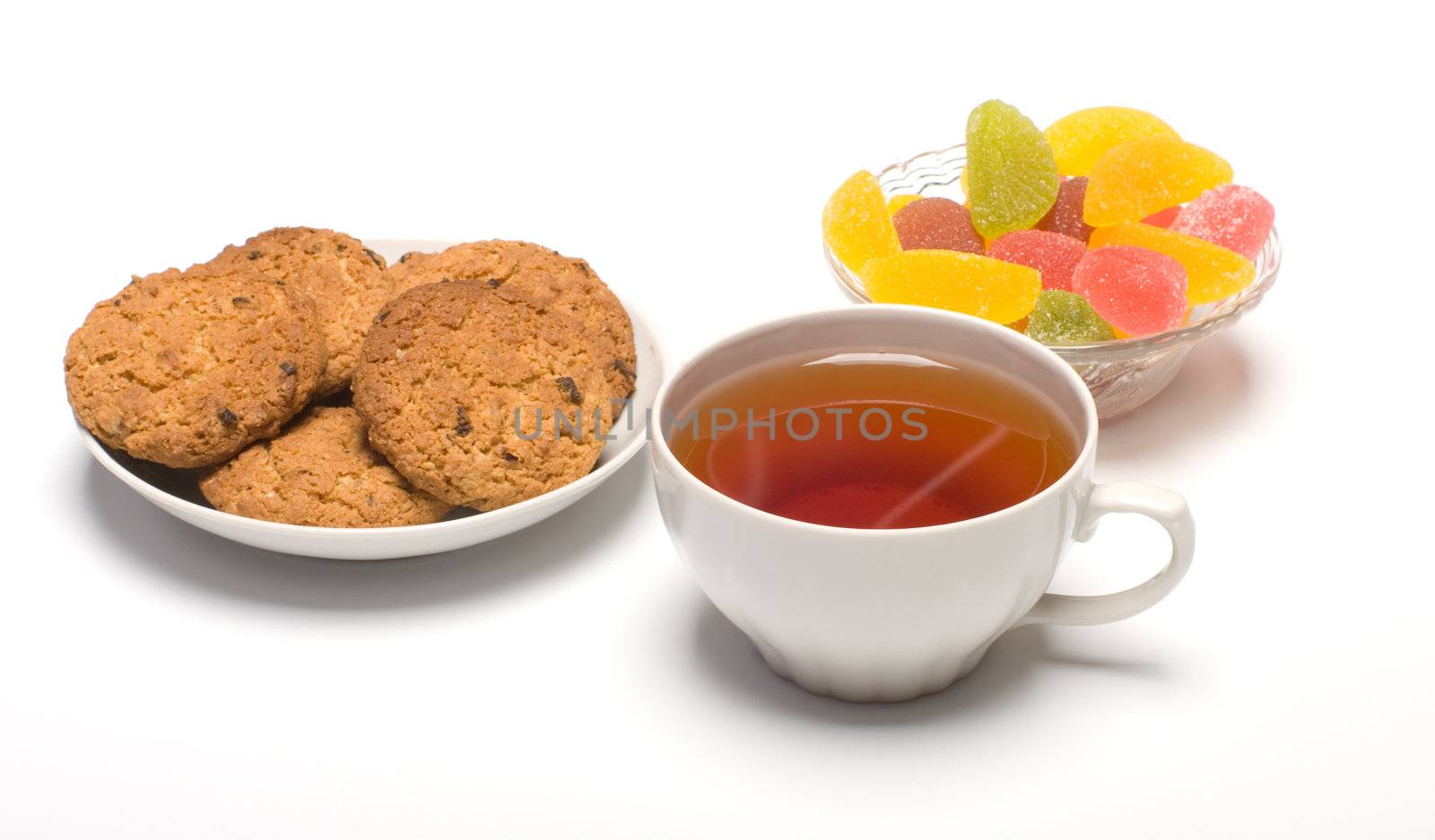 Tea colour fruit candy and cookies close up