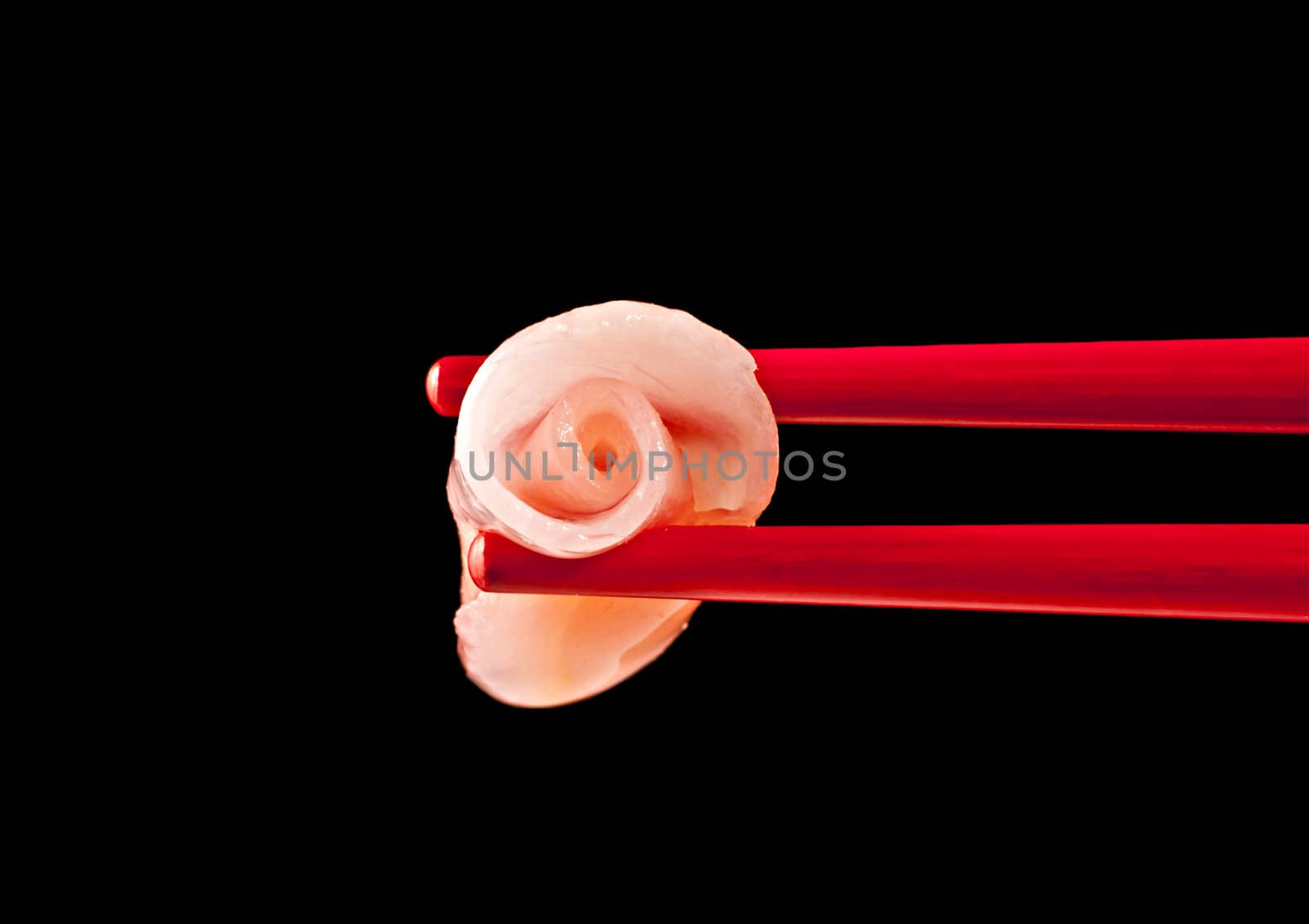 Pink ginger, red chopsticks on a black background
