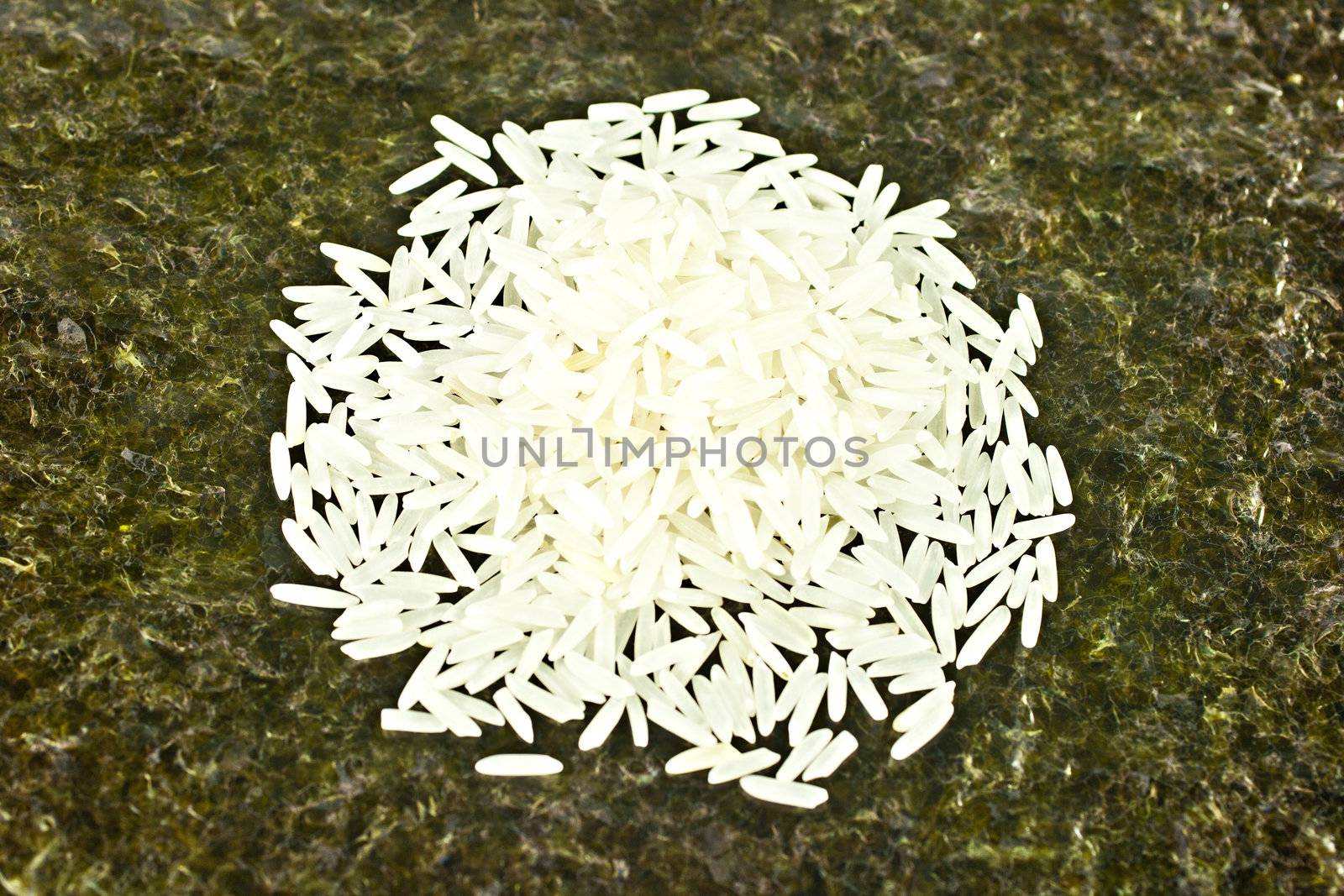 Basmati rice on the sushi maker weed background
