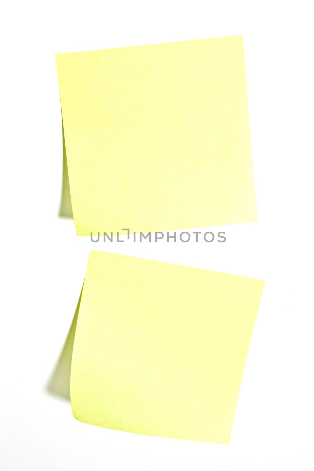 Two yellow sticky paper notes on a white background.
