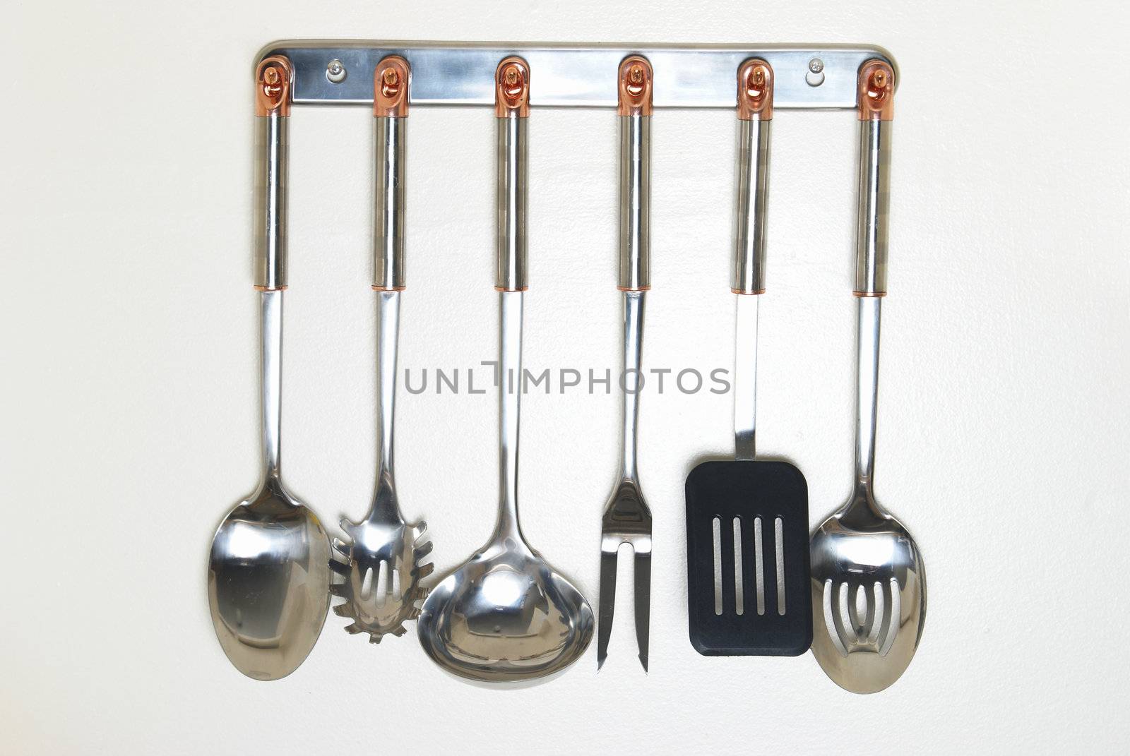 A rack of kitchen utensils hanging on the wall.