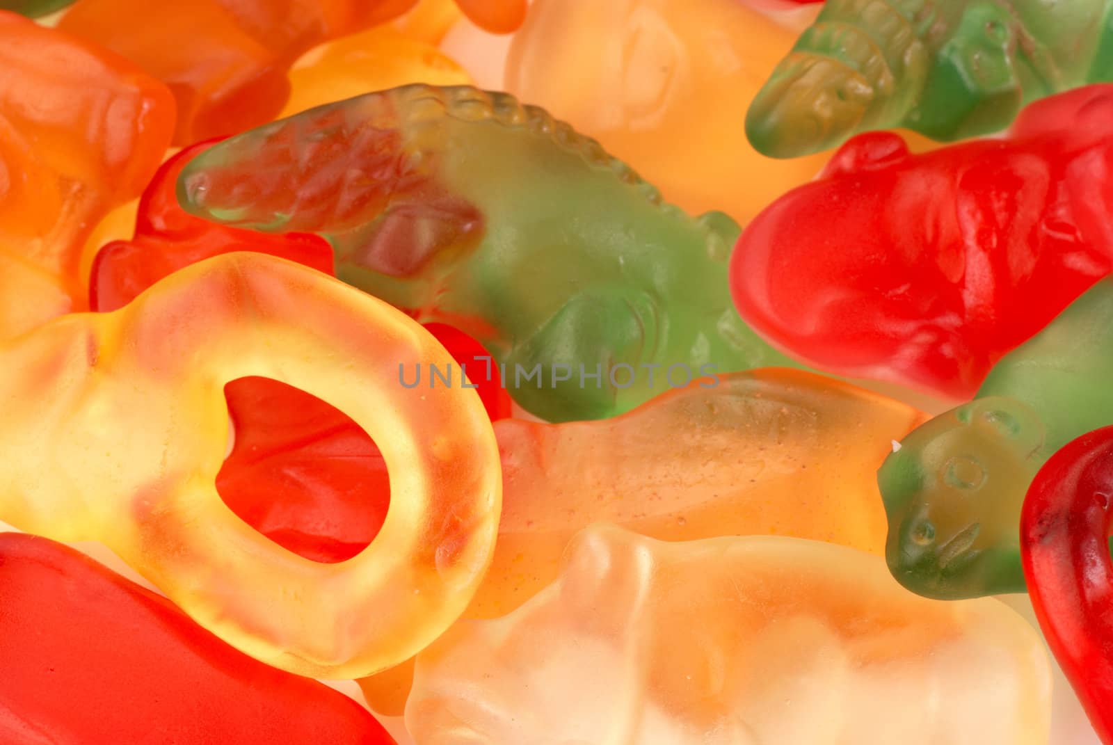 Closeup take of a heap of multicolored gumi candy, food background