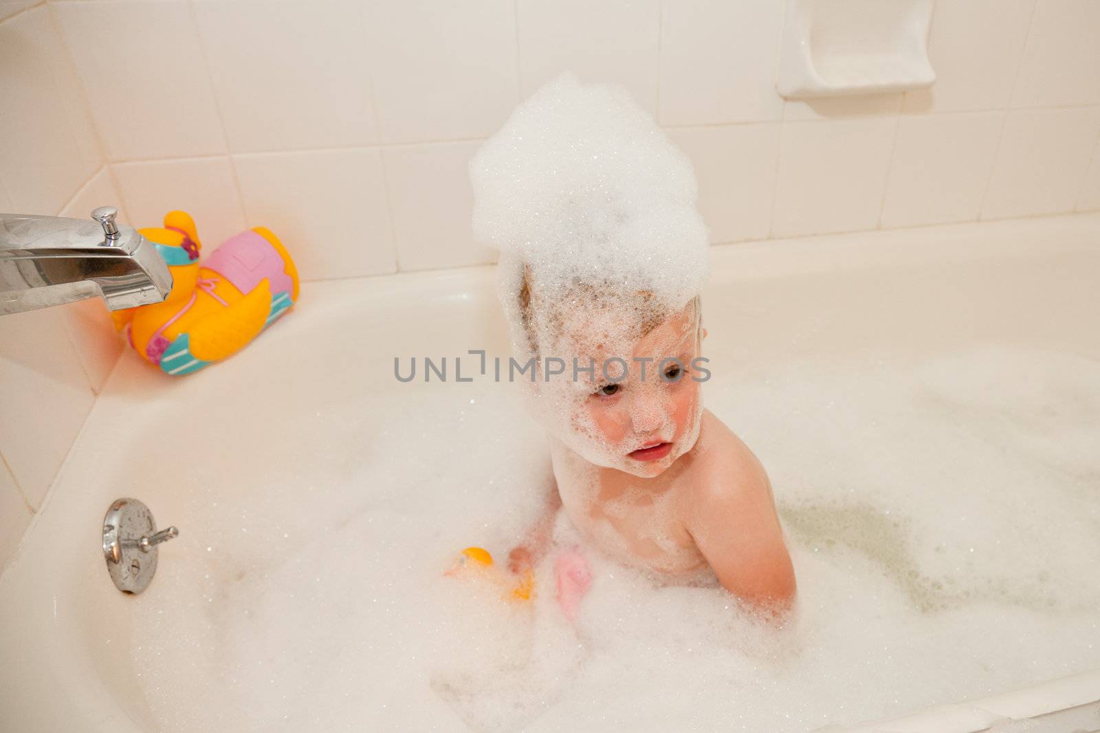 Bubbles on top of the water, less ambiguously known as a foam bath can be obtained by adding a product containing foaming surfactants to water and temporarily aerating it by agitation