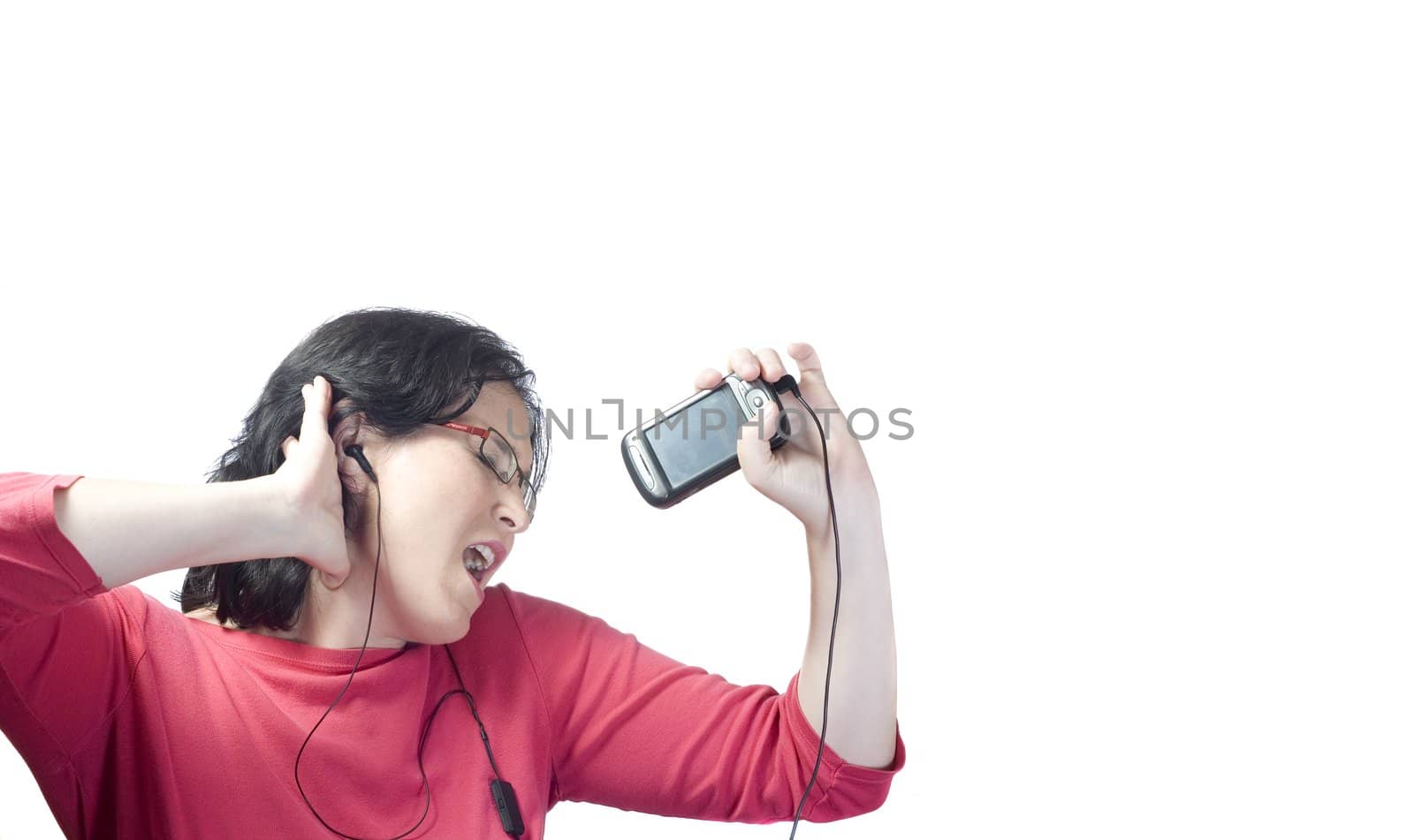 young woman listening, dancing and singing to music in a mp3 device