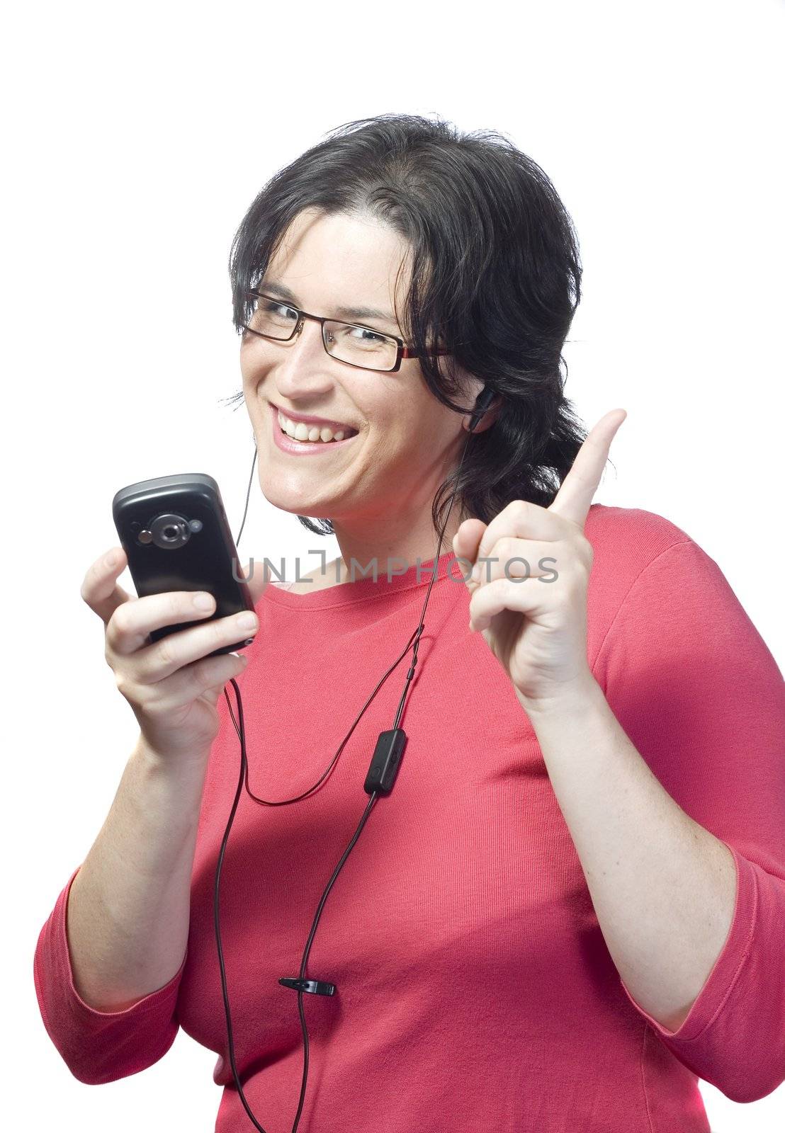 young woman listening, dancing and singing to music in a mp3 device