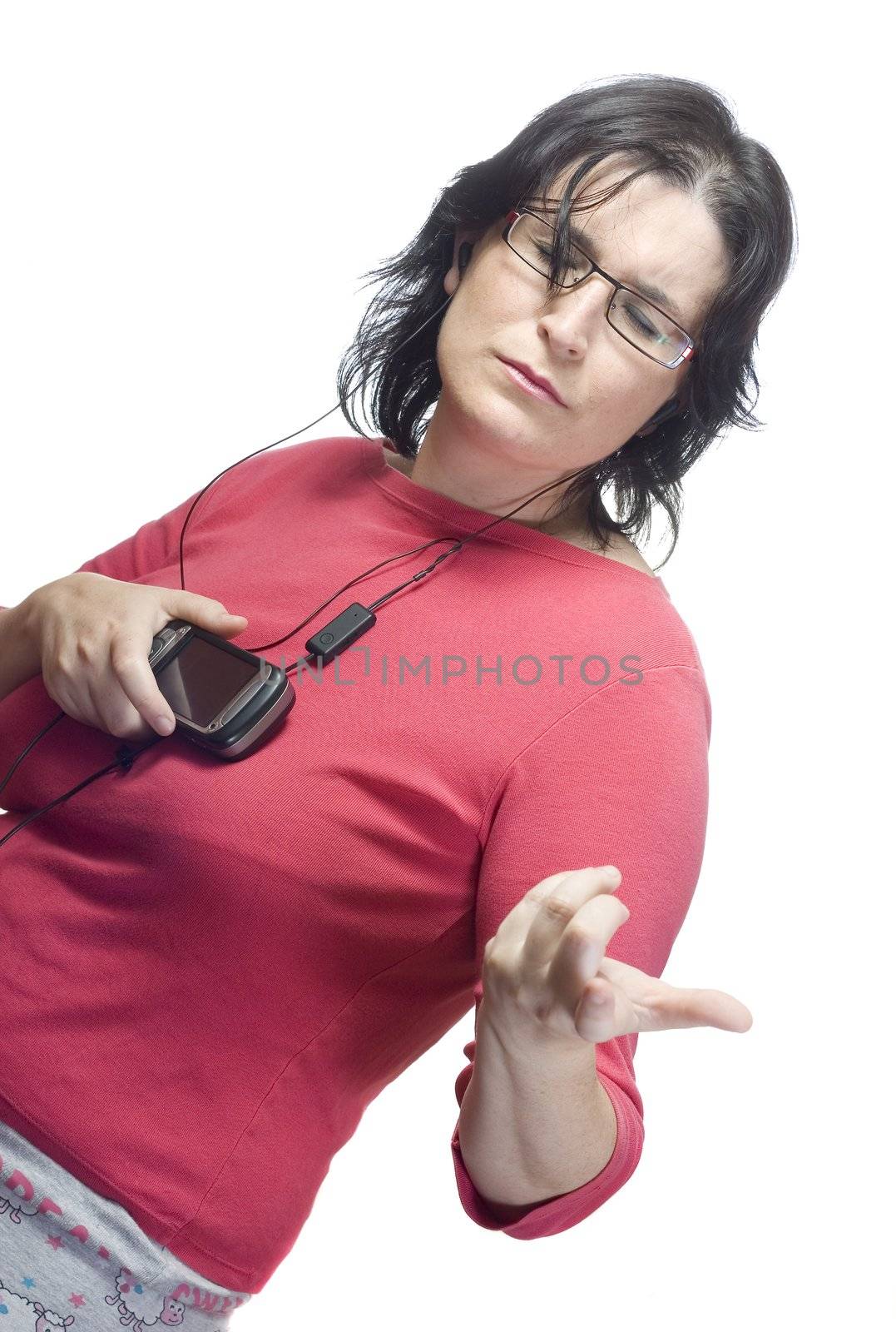 young woman listening, dancing and singing to music in a mp3 device