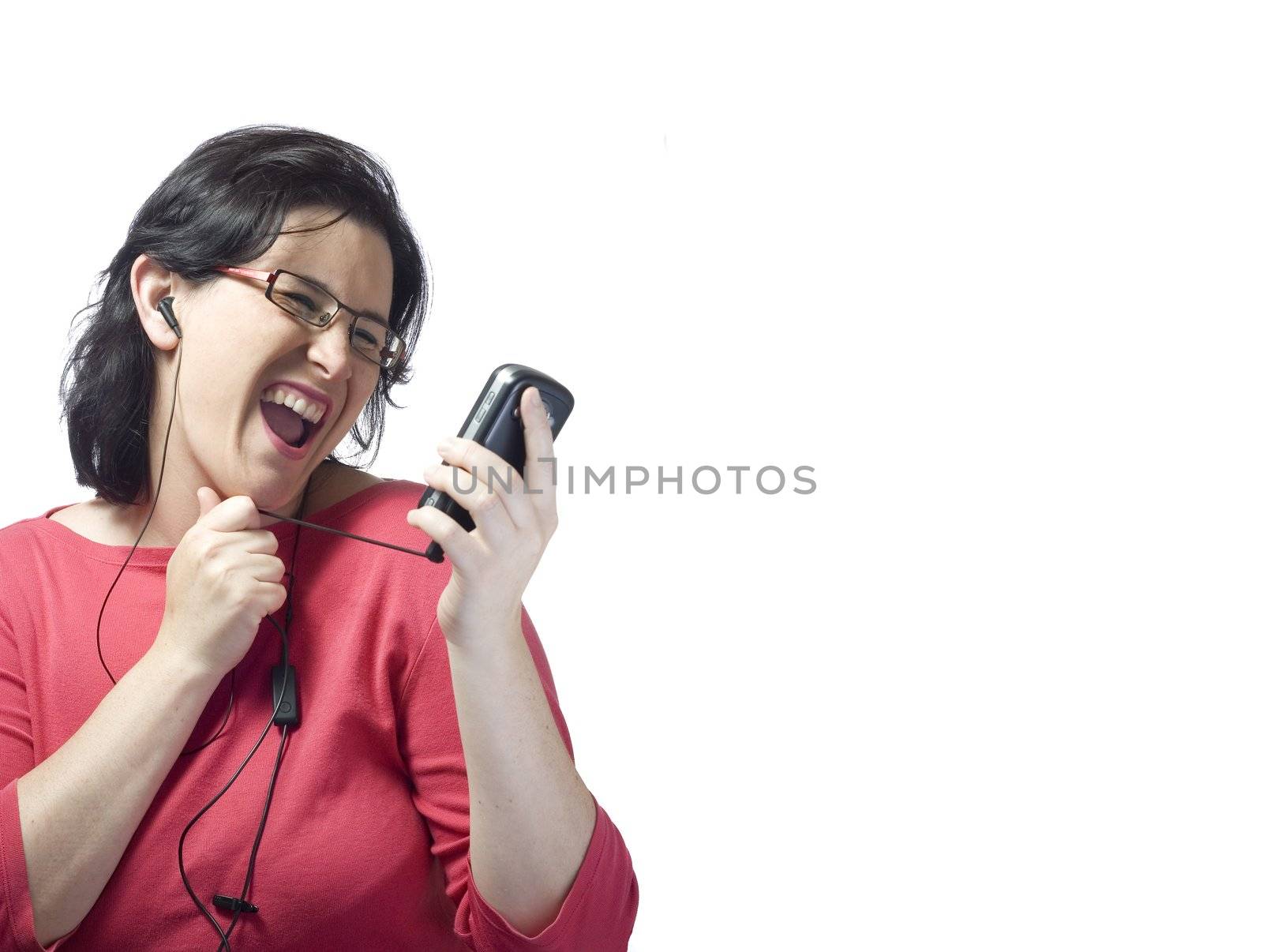 young woman listening, dancing and singing to music in a mp3 device