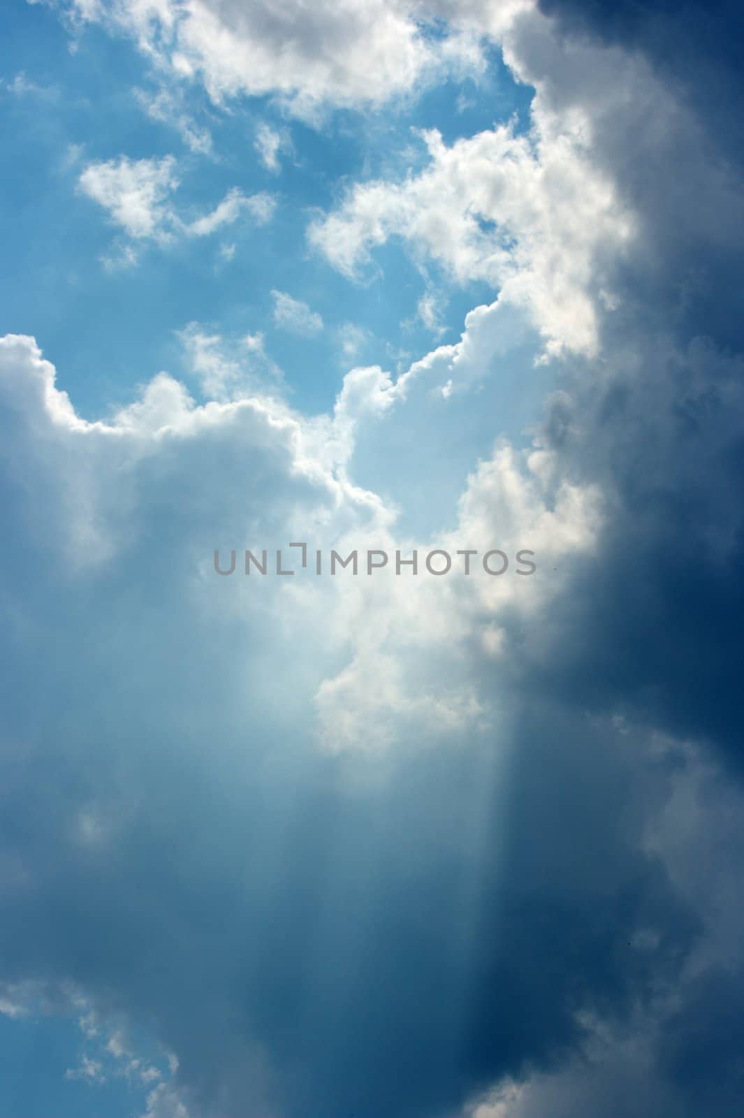 Cloudy blue sky with ray of light