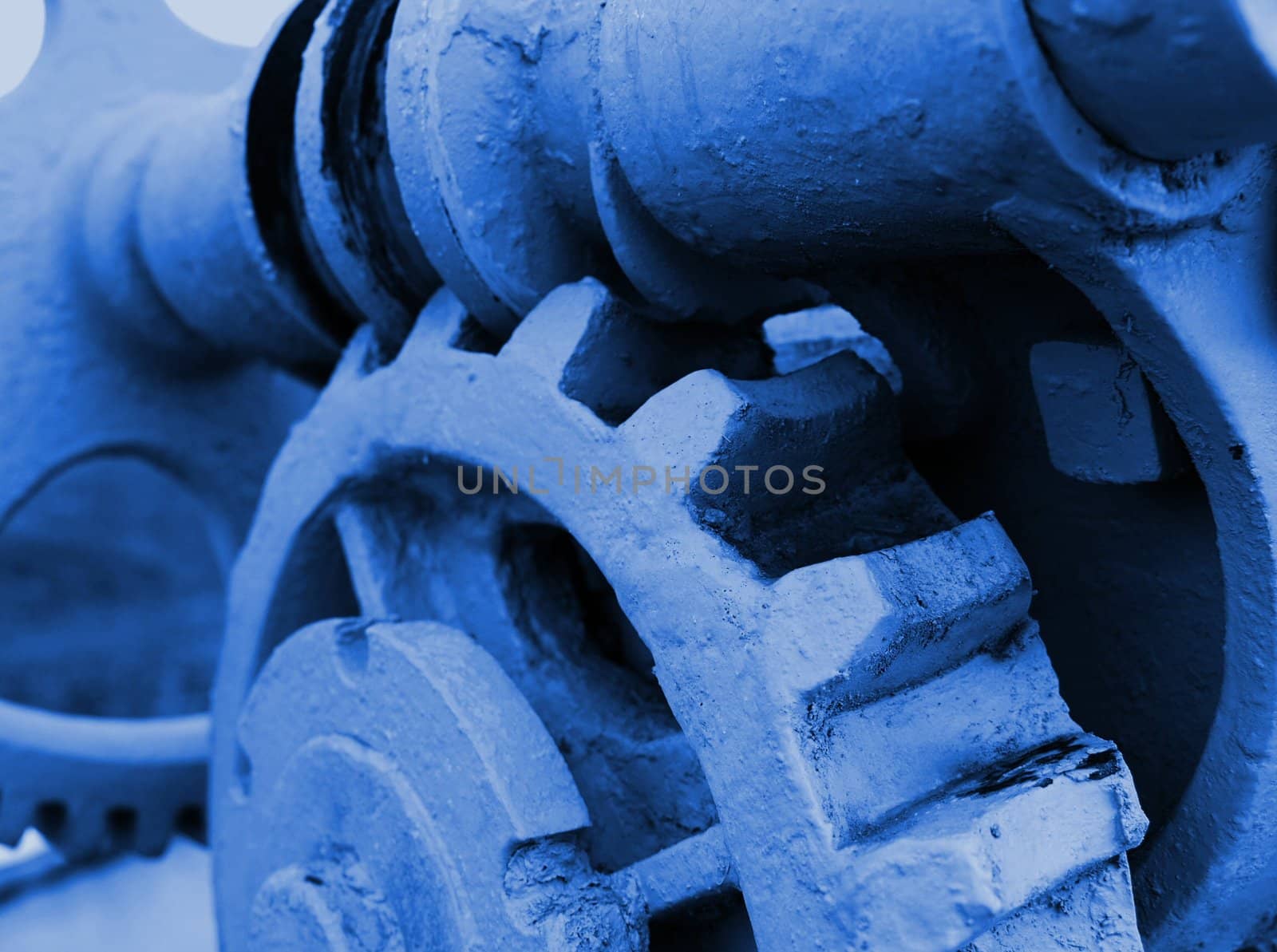 Cogwheels in a machinery in blue tone