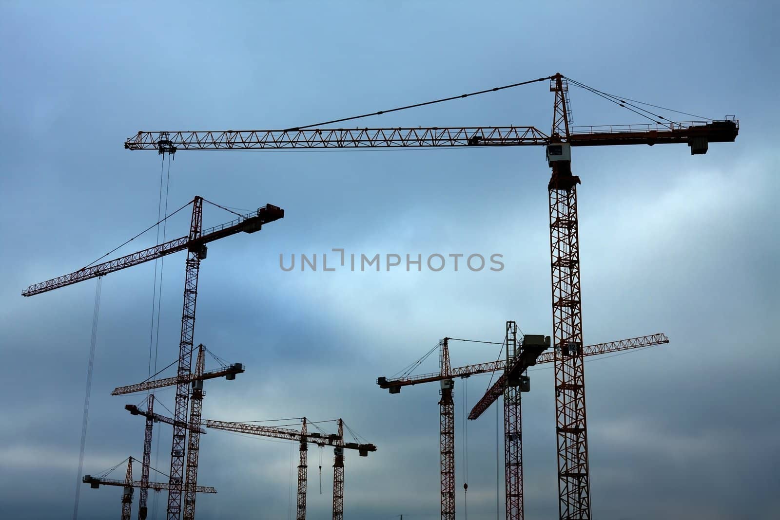 Many tower cranes at a construction site