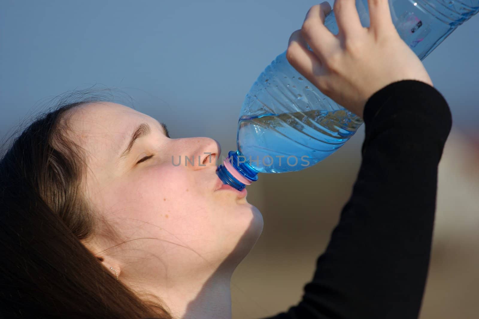 Portrait of a girl drinking water from a bottle