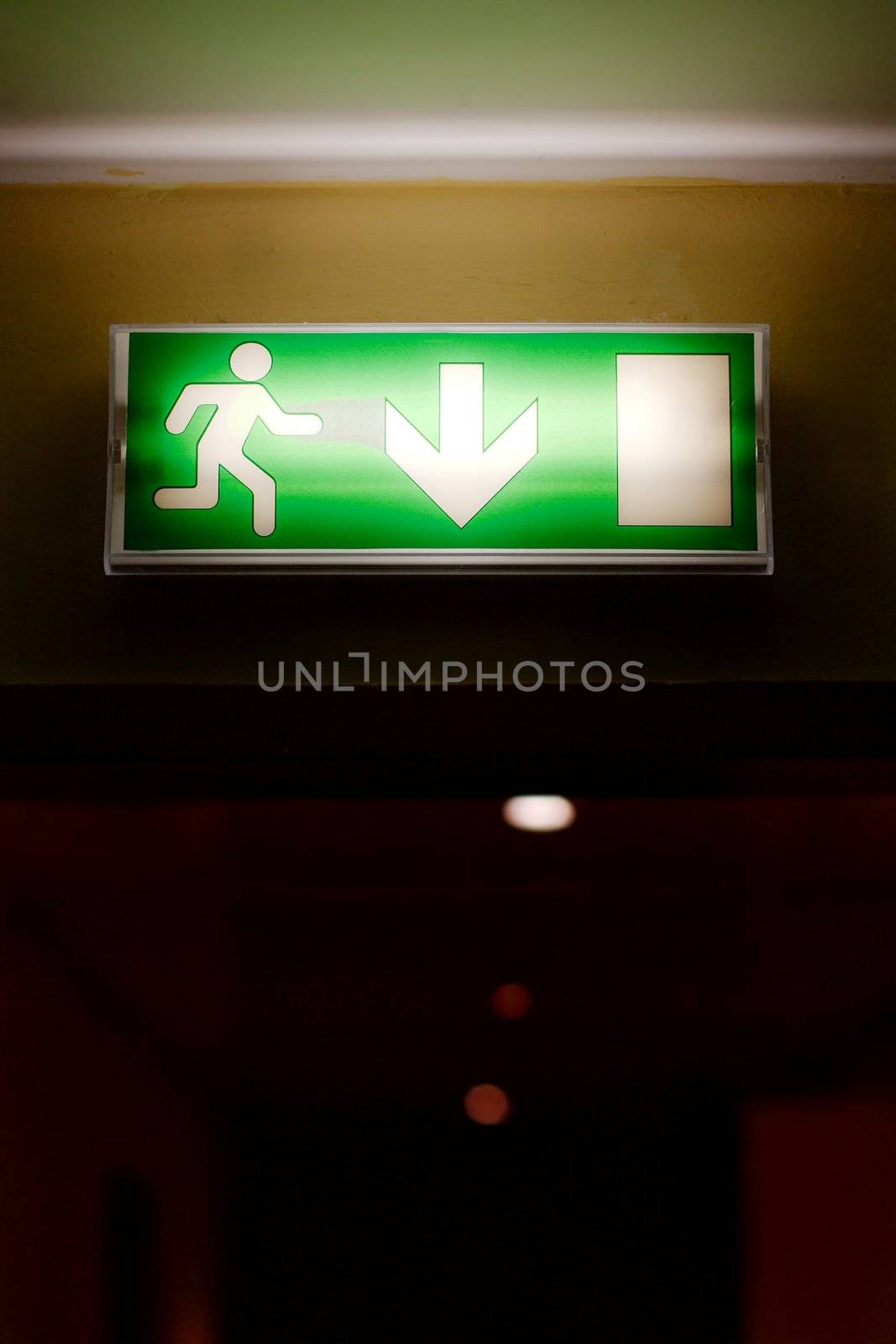 Emergency exit sign glowing in a corridor