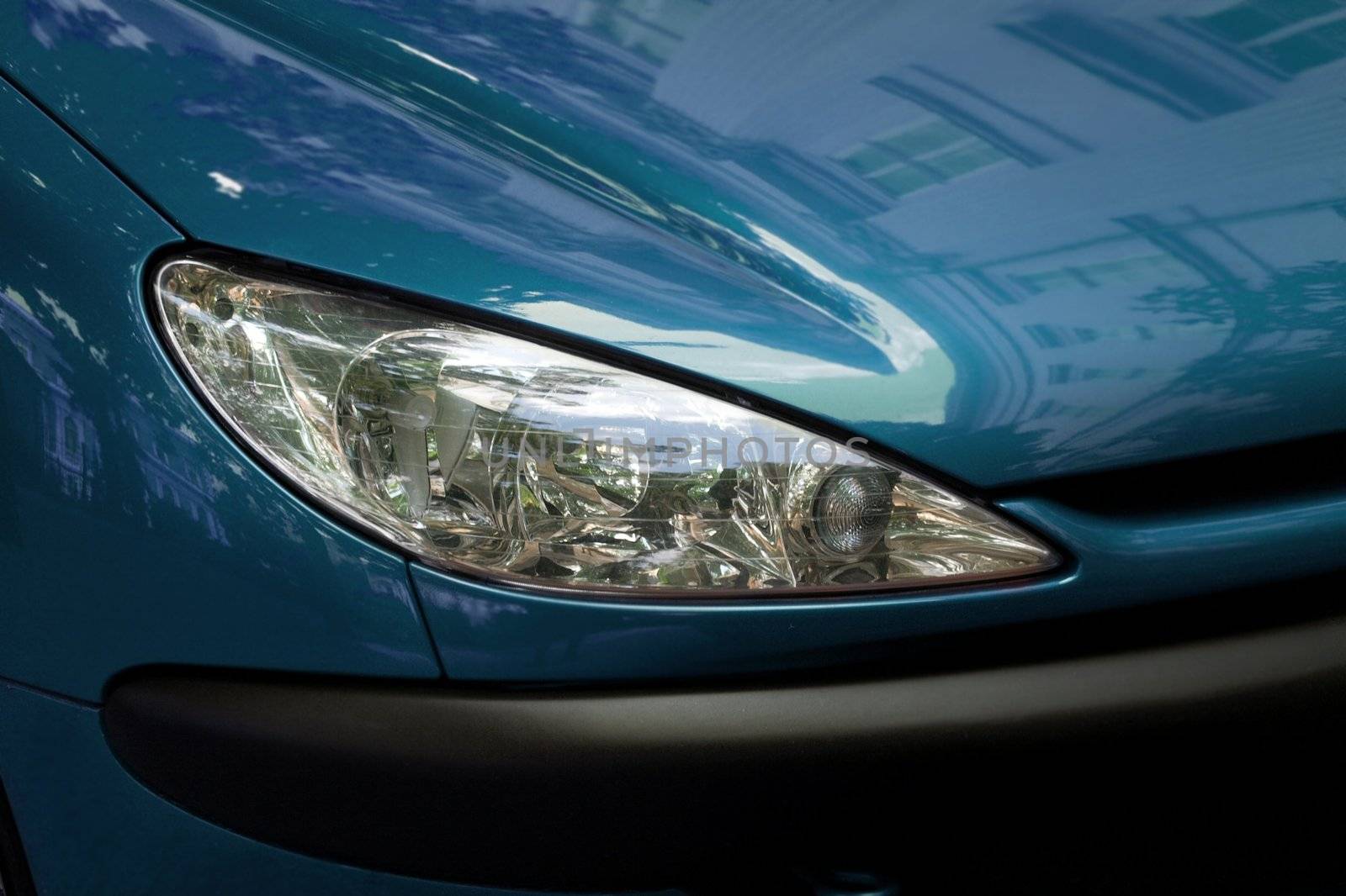 Headlights of shiny blue car