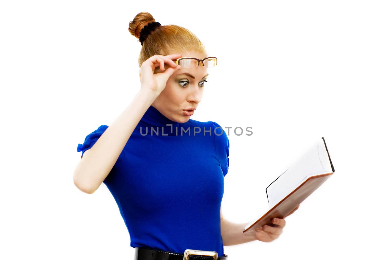 Surprised businesswoman with glasses looking into notebook over white