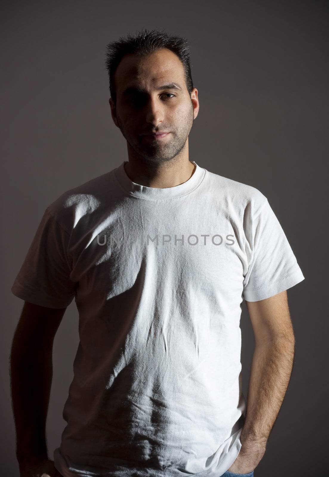 dark image of a no shaved dangerous looking guy in a rude pose