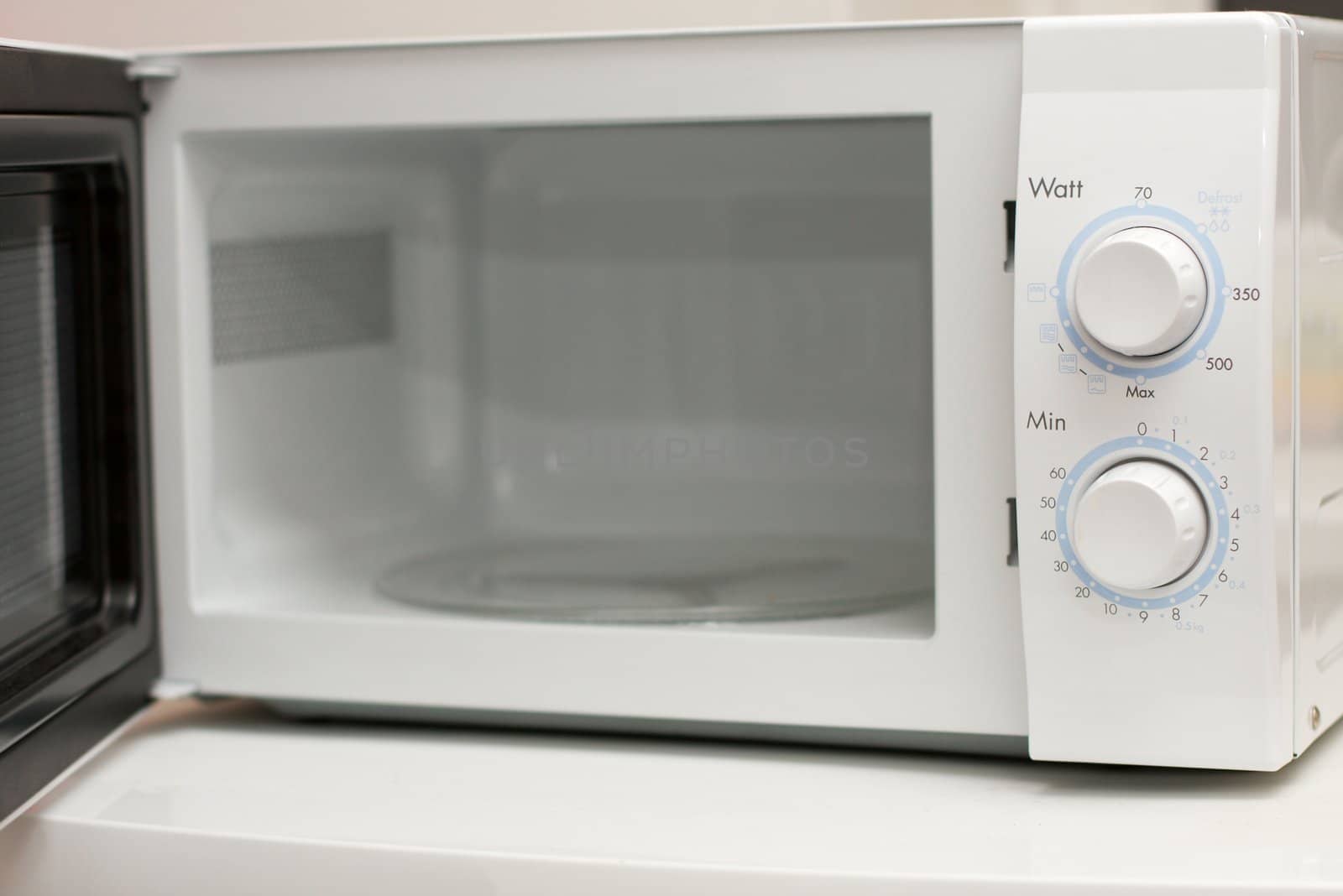 Open, white microwave oven