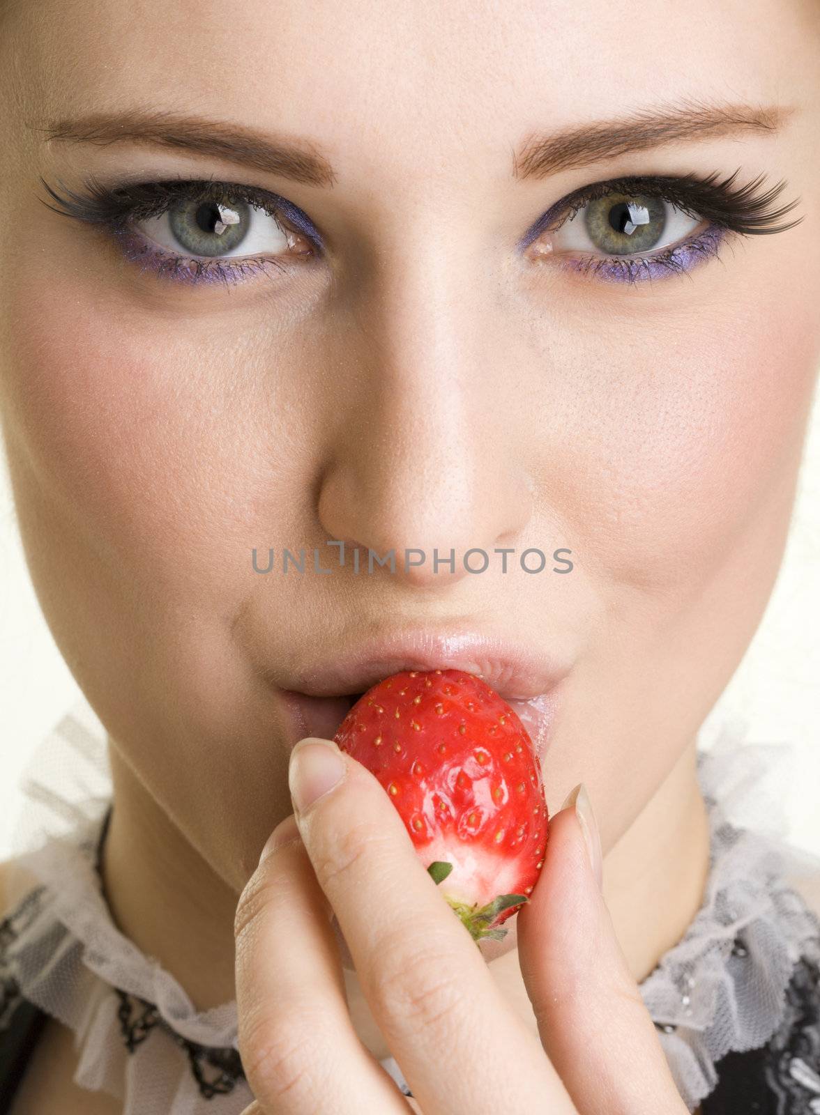 Beautyfull girl with strawberry in her mouth