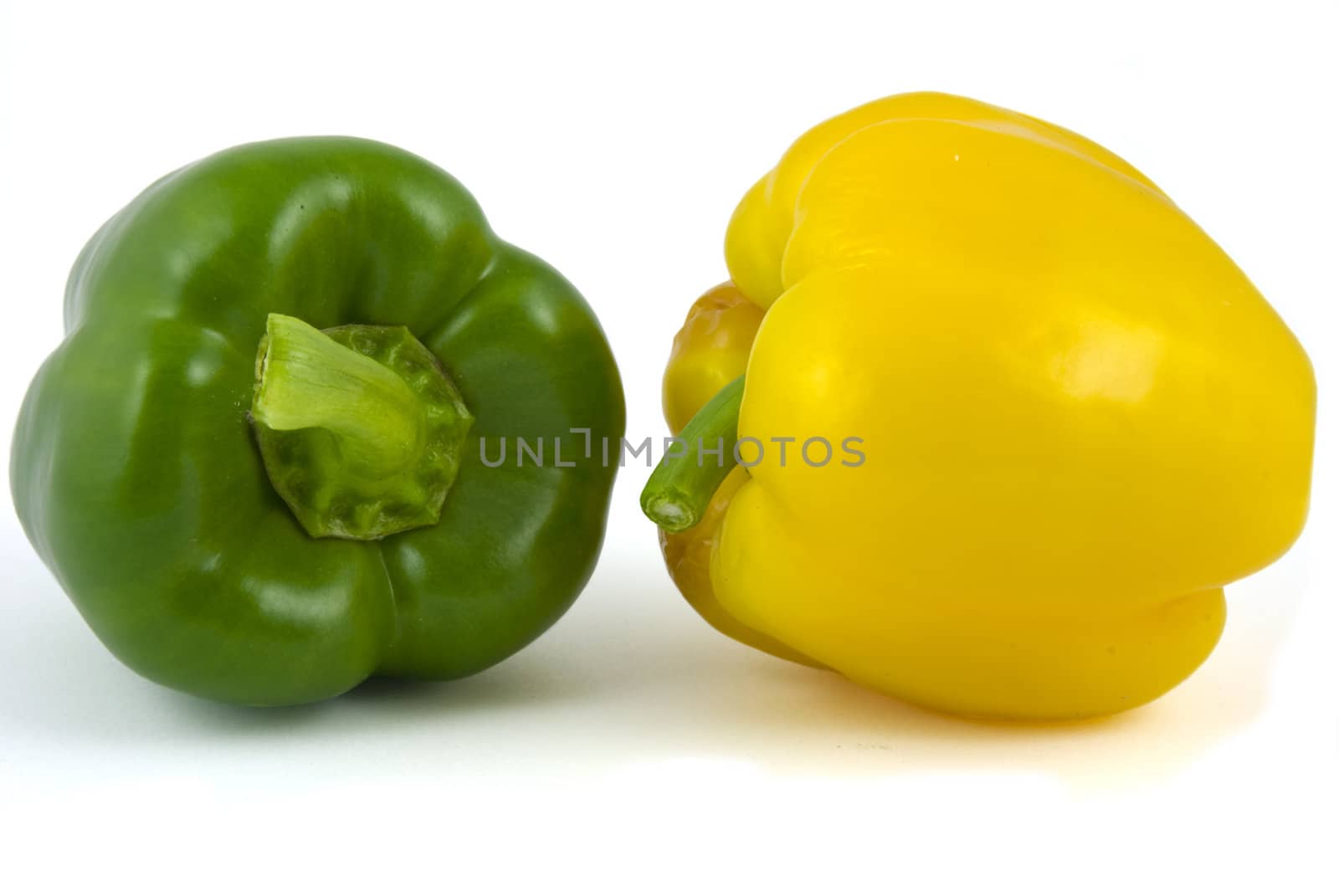 Yellow and green bell peppers isolated on white background