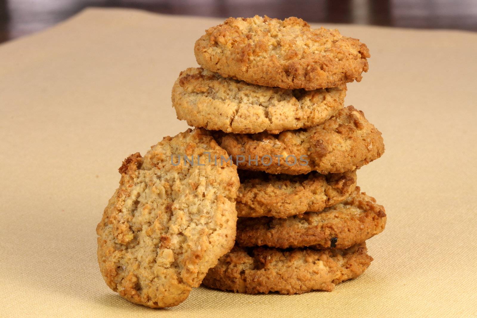 Fresh baked Stack of warm oatmeal  cookies on fine tablecloth made of linen, shallow DOF