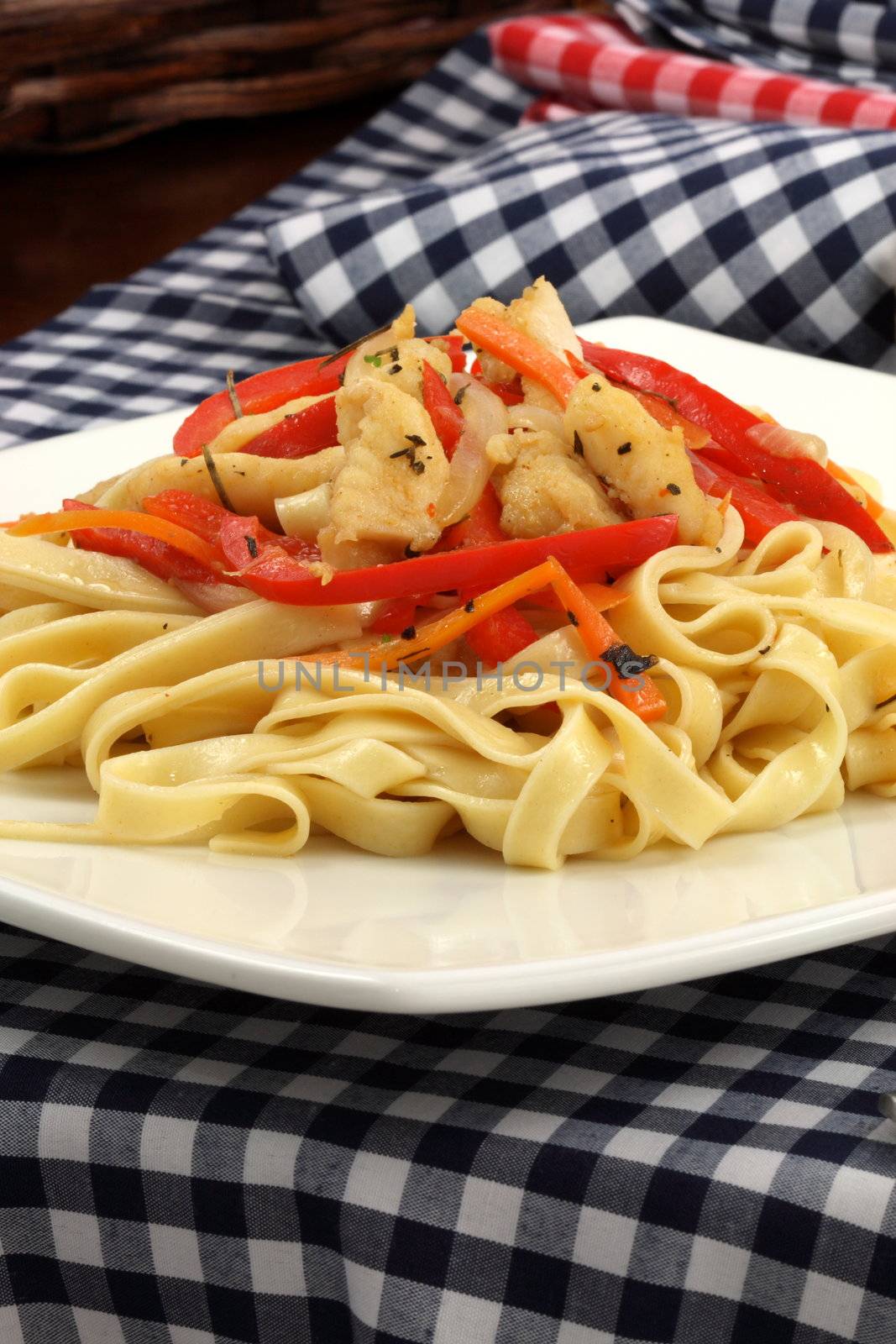 Gourmet exquisite halibut  fettuccine pasta  on fancy dinner plate   