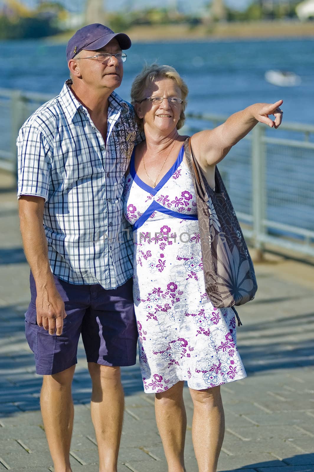 Aged loving couple walking and holding each other 